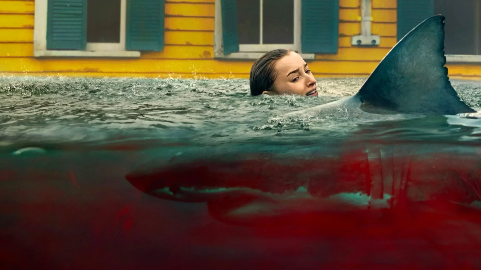 Phoebe Dynevor with a shark in Thrash